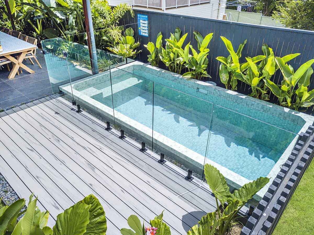 a swimming pool in an outdoor area of a residential property