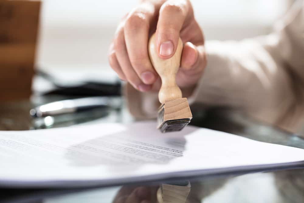 person stamping a document